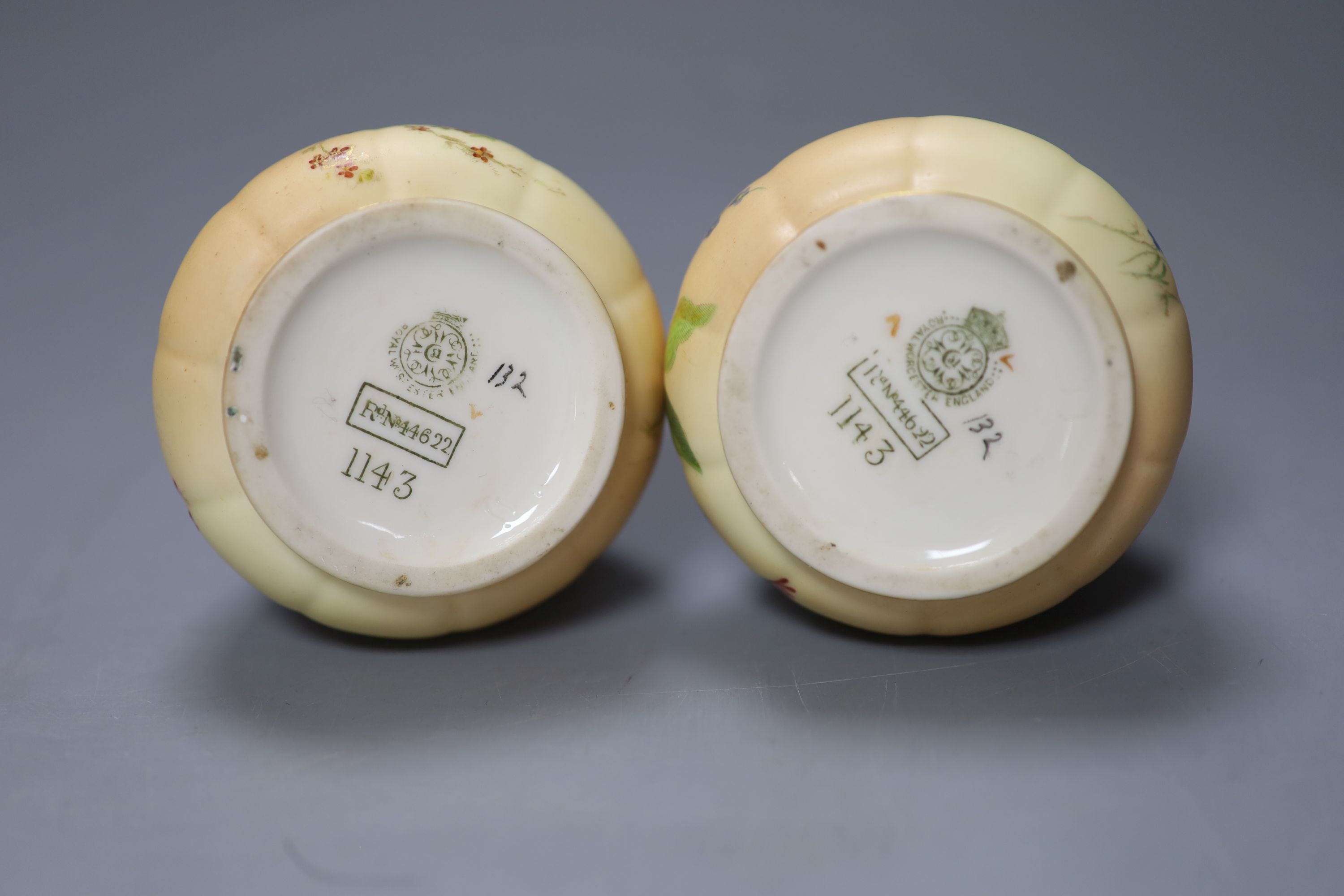 A pair of Royal Worcester blush ivory ewers painted and gilded with flowers, green mark, date code 1900, height 15cm